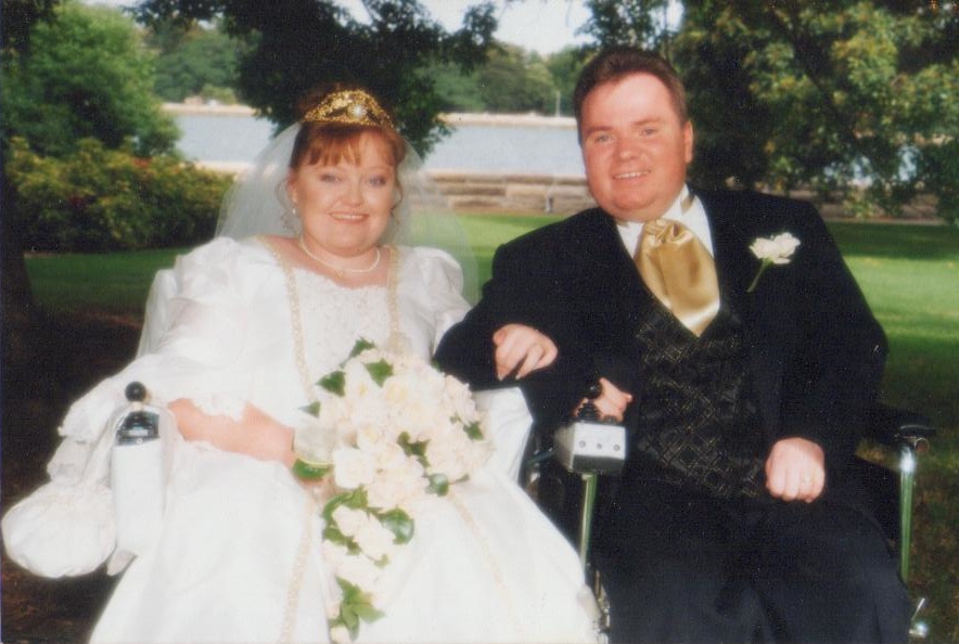 a young bride and groom smile for their wedding photo